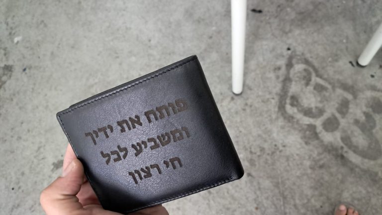 ארנק עם חריטה פותח את ידיך ומשביע לכל חי רצון