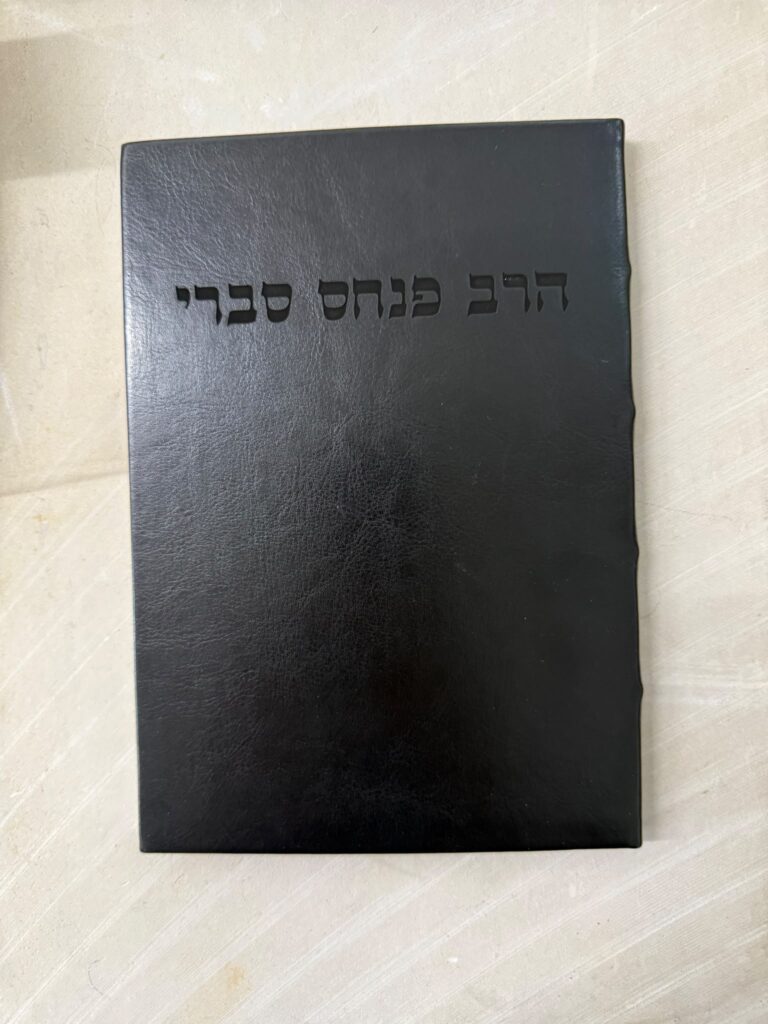 חריטה על מחברת יוקרתית בכריכת עור שחורה בשם הרב פנחס סברי