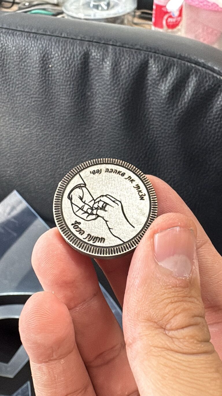 חריטה על מטבע מתכת עם ציור ידיים וטבעת והפסוק מצאתי את שאהבה נפשי