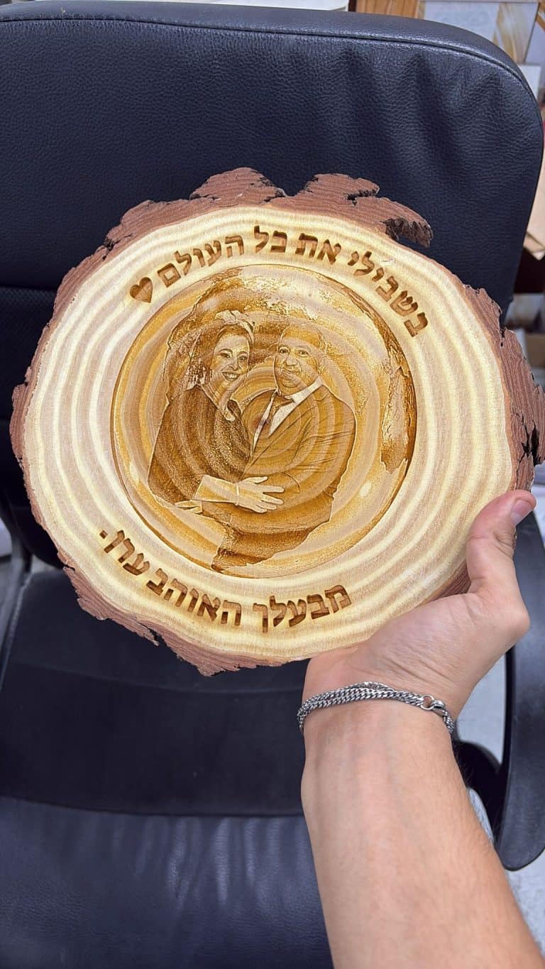 חריטה של תמונה זוגית עם רקע כדור הארץ מאחורה על פרוסת גזע